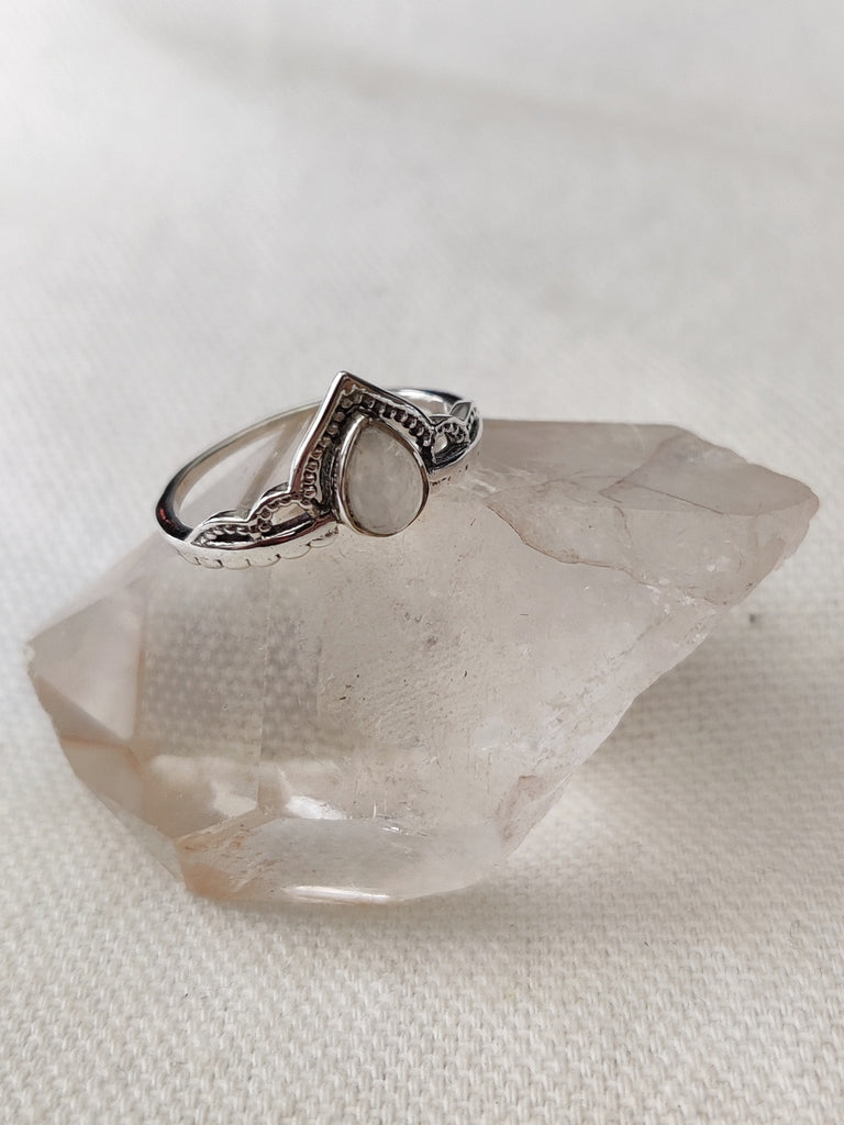 This is a sterling silver ring with a tear drop design and moonstone crystal gemstone rainbow white in colour, sitting on top of a clear quartz crystal, both available at our third eye crystal store in Auckland New Zealand