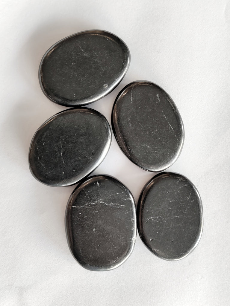 This is a bundle of shungite palm stone crystals, black in colour and available at our third eye crystal store in Auckland, New Zealand