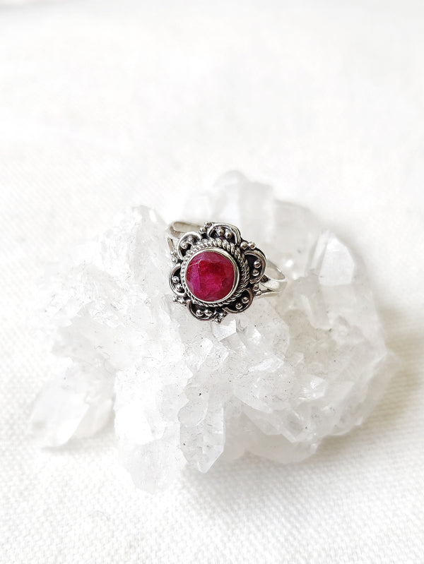 This is a sterling silver ring with a floral design and ruby crystal gemstone that is hot pink in colour, sitting on top of a clear quartz crystal, both available at our third eye crystal store in Auckland New Zealand