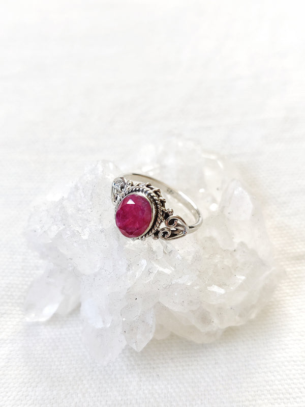 This is a sterling silver ring with a ruby gemstone that is hot pink in colour, sitting on top of a clear quartz crystal, that are both from our third eye crystal and jewellery store in Auckland New Zealand
