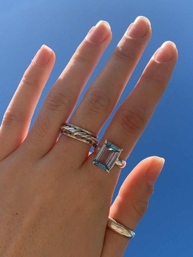 This is a hand wearing the Zoe Ring in our blue topaz crystal, that is light blue in colour from our third eye crystal and jewellery store in Auckland New Zealand